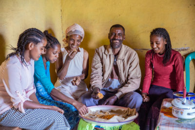 Father eating dinner with wife and children in Ethiopia Father eating dinner with wife and children in Ethiopia