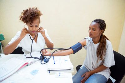 Health worker taking care of a female patient. Health worker taking care of a female patient.