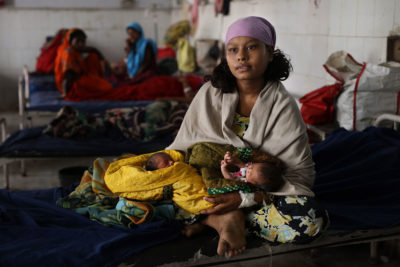 A mother holds her newborn twins, who were delivered under the supervision of trained health professionals at Sri Krishna Medical College and Hospital, a public health facility. Institutional births are one of the Indian government's key strategies to reduce infant and maternal mortality and improve the overall health of the mother and child. An average of 7,000 births take place at Sri Krishna Medical College and Hospital each year.
—Muzaffarpur District, Bihar, India A mother holds her newborn twins, who were delivered under the supervision of trained health professionals at Sri Krishna Medical College and Hospital, a public health facility. Institutional births are one of the Indian government's key strategies to reduce infant and maternal mortality and improve the overall health of the mother and child. An average of 7,000 births take place at Sri Krishna Medical College and Hospital each year.
—Muzaffarpur District, Bihar, India